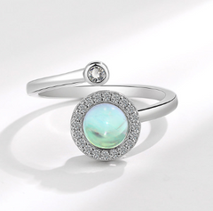 Elegant adjustable ring featuring a glowing opalescent center stone surrounded by small sparkling crystals on a polished white gold electroplated band.