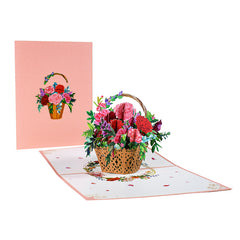 Intricately designed 3D pop-up floral bouquet card featuring a colorful arrangement of pink and red flowers in a woven basket, ideal as a heartfelt gift for Mother's Day.