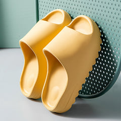 Pair of yellow platform beach sandals made from lightweight EVA foam with thick textured soles, designed for comfort and casual wear.
