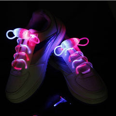 White sneakers featuring ultra-bright LED light-up shoelaces glowing in pink and blue, designed for night running, parties, and kids' footwear.