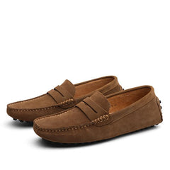 Pair of men's genuine suede penny loafers in brown with classic slip-on design and stitched detailing, ideal for casual and formal occasions.