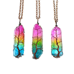 Three handcrafted crystal pendants featuring rainbow aura quartz with copper wire wrapped in a tree of life design, hanging from bronze chains against a white background.