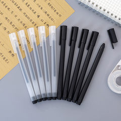 A collection of black and translucent pens with caps arranged alongside a sheet of paper with Chinese characters and a spiral notebook, showcasing sleek writing instruments designed for precision and comfort.