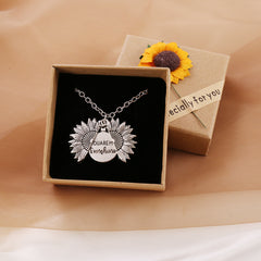 Silver sunflower locket necklace with a hidden "You Are My Sunshine" message inside, displayed in a gift box adorned with a decorative sunflower and a "specially for you" tag.