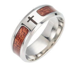 Men's ring featuring a polished stainless steel band with wood inlay sections and an engraved cross, blending rustic and modern styles for a meaningful accessory.