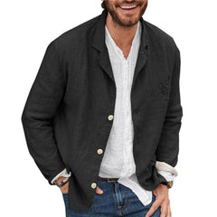 Man wearing a slim fit, black cotton-linen blazer over a white casual shirt and blue jeans, showcasing a lightweight, versatile summer jacket style.