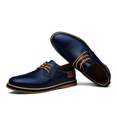 Pair of men's blue genuine leather lace-up oxford shoes with brown laces and contrasting welt stitching, designed for comfortable business casual wear.
