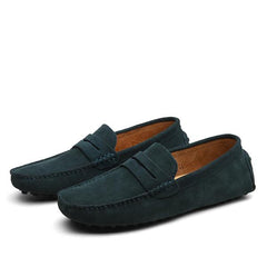 Pair of men's genuine suede penny loafers in deep blue with classic slip-on design and textured sole for casual and formal wear.