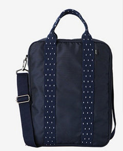 Minimalist matte black waterproof large capacity travel backpack featuring multiple zippered compartments and ergonomic straps, displayed in a clean lifestyle setting
