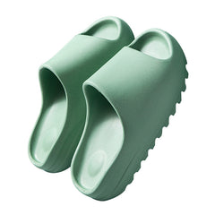 Lightweight green platform beach sandals made of durable eco-friendly EVA foam with thick, cushioned soles designed for all-day comfort and outdoor use.