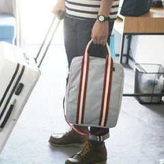 A man carrying a minimalist, modern large-capacity backpack, demonstrating its versatile use as both a professional work bag and a weekend carry-on.