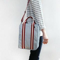 A man carrying a minimalist, modern large-capacity backpack, demonstrating its versatile use as both a professional work bag and a weekend carry-on