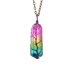 Pendant necklace featuring a handcrafted rainbow aura quartz crystal with a detailed wire-wrapped Tree of Life design, hanging from a copper chain.