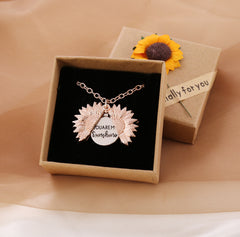 Rose gold sunflower locket necklace with a hidden “You Are My Sunshine” message, presented in a gift box adorned with a sunflower decoration.