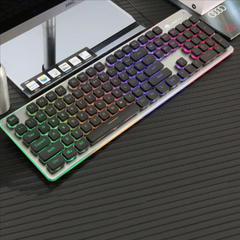 RGB backlit wired gaming keyboard with 104 keys, featuring a membrane design and colorful LED lighting, placed on a black textured desk surface.