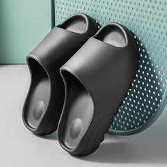 Black lightweight platform beach sandals made of durable eco-friendly foam with a cushioned footbed for comfortable all-day wear.