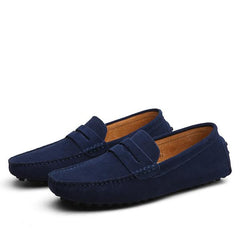 Pair of men's genuine suede penny loafers in deep blue with classic slip-on design and stitched detailing, perfect for casual and formal wear.