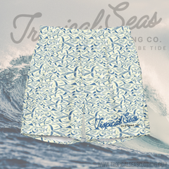 Blue and white men's swim trunks with an all-over fish pattern and Tropical Seas Clothing Co. logo, made from quick-dry recycled polyester fabric.