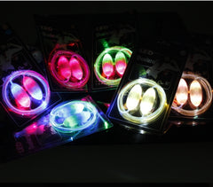 Colorful glowing LED shoelaces in green, multicolor, white, blue, and yellow, displayed in packaging with bright illumination, ideal for night running and parties.
