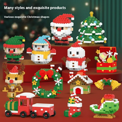 Christmas-themed tiny building block figures including Santa Claus, a Christmas tree, a reindeer, a wreath, a toy train, and festive holiday decorations arranged on red platforms.