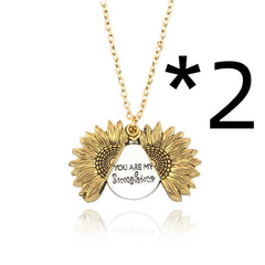 Gold sunflower locket necklace with a hidden message that reads "You Are My Sunshine," designed as a sentimental gift for women and men.