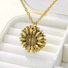 Gold sunflower locket necklace with intricate petal details, displayed in a white jewelry box, symbolizing a sentimental and heartfelt gift for women and men.