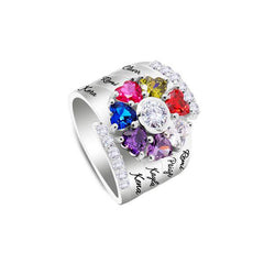 Silver personalized ring featuring multiple colorful heart-shaped birthstones and custom engraved family names, accented with small clear crystals.
