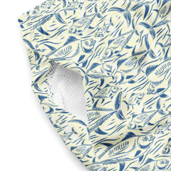 Close-up of men's swim trunks made from polyester with a blue and animal pattern featuring various fish illustrations and a white mesh pocket lining.