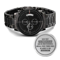 Men’s black chronograph watch with a sleek metal band and engraved scripture on the back, featuring a date display and multiple subdials for precise timekeeping.
