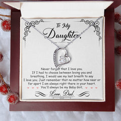 Heart-shaped silver necklace with sparkling crystals displayed in a gift box featuring a heartfelt message from a father to his daughter, perfect for sentimental gifts.