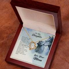 Old Wolf - Forever Love Necklace displayed in a wooden box with a sentimental message from a mother to her daughter featuring a wolf illustration and a gold heart-shaped pendant.