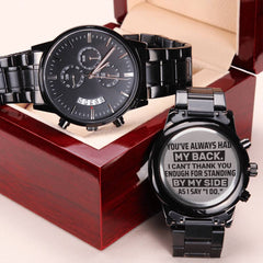 Men’s black chronograph watch with a stainless steel band, displayed in a polished wooden gift box, featuring an engraved heartfelt message for a groomsman on the back.