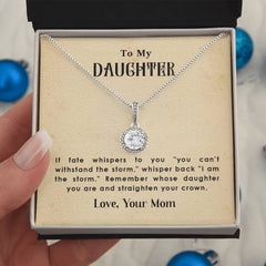 Silver necklace with a sparkling round pendant displayed in a gift box, accompanied by an inspiring message from a mother to her daughter about strength and resilience.