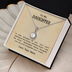 Silver necklace with a sparkling round pendant displayed in a gift box featuring an inspirational message from a mother to her daughter about strength and resilience.