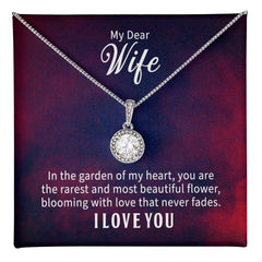 Silver necklace with a round crystal pendant displayed on a card that reads a heartfelt message to "My Dear Wife" expressing love and appreciation as a rare and beautiful flower in the heart’s garden.