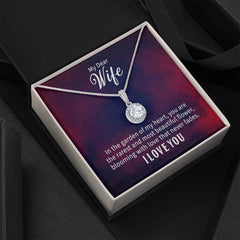 Silver necklace with a sparkling round pendant displayed in a gift box with a romantic message for a wife expressing love and admiration.