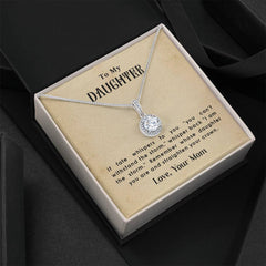 Silver necklace with a sparkling round pendant displayed in a gift box featuring an inspiring message to a daughter from her mother.