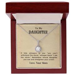 Elegant silver necklace with a sparkling round pendant, displayed in a polished wooden gift box alongside an inspiring message from a mother to her daughter.