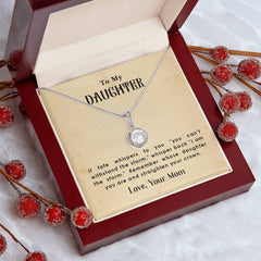 Silver necklace with a round pendant displayed in a red gift box, accompanied by a heartfelt message from a mother to her daughter inside the box lid.