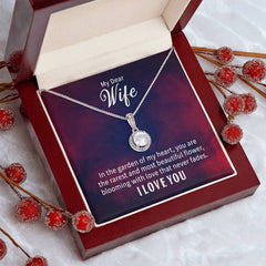 Elegant silver necklace with a sparkling round pendant displayed in a red velvet gift box, accompanied by a heartfelt message for a wife expressing love and admiration.
