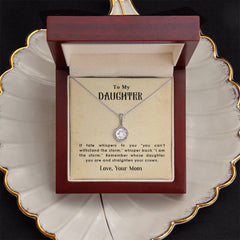 Silver necklace with a round pendant displayed in a wooden gift box, accompanied by a heartfelt message from a mother to her daughter encouraging strength and resilience.
