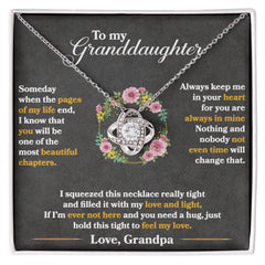 Silver love knot necklace with cubic zirconia crystals displayed on a black background featuring a heartfelt message from a grandpa to his granddaughter, surrounded by floral accents.