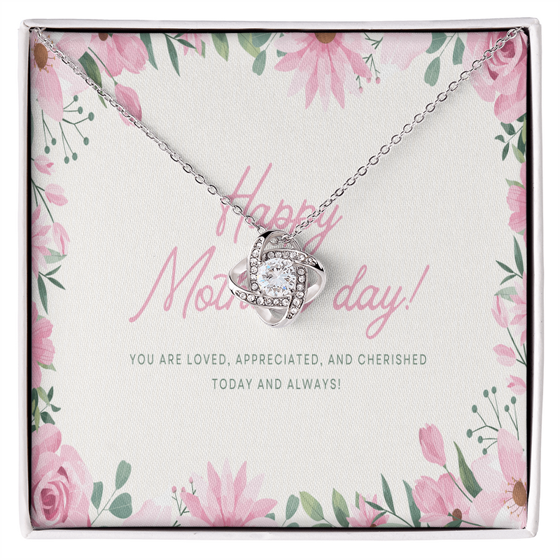 14k white gold love knot necklace with 6mm cubic zirconia stone on a mahogany luxury box.