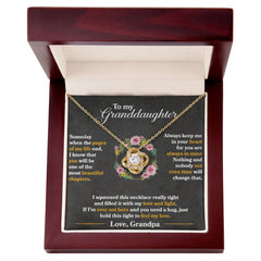 Gold love knot necklace adorned with sparkling cubic zirconia crystals displayed inside an elegant wooden gift box with a heartfelt message for a granddaughter.