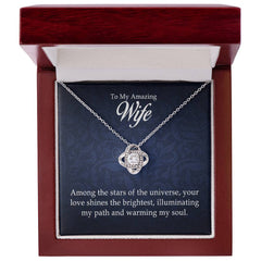 Silver love knot necklace with sparkling stones displayed in an elegant wooden gift box featuring a heartfelt message for a wife.
