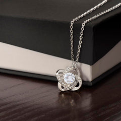 Love Knot Necklace pendant in silver with a central clear crystal and pave accents, ShineOn Fulfillment.