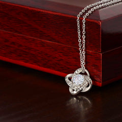 Love Knot Necklace, silver-tone jewelry with a sparkling round centerpiece and entwined pave loops.