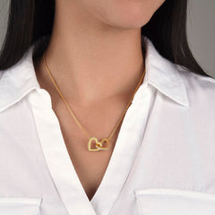 Interlocking Hearts Necklace in gold on a model wearing a white button-down shirt