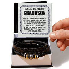 Black braided men's leather bracelet with gold and silver accents displayed in gift box alongside a heartfelt message card for a grandson from grandparents.