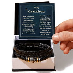 Black braided leather bracelet with engraved clasp and gold-tone accents displayed in an open gift box alongside a heartfelt message card for a grandson.